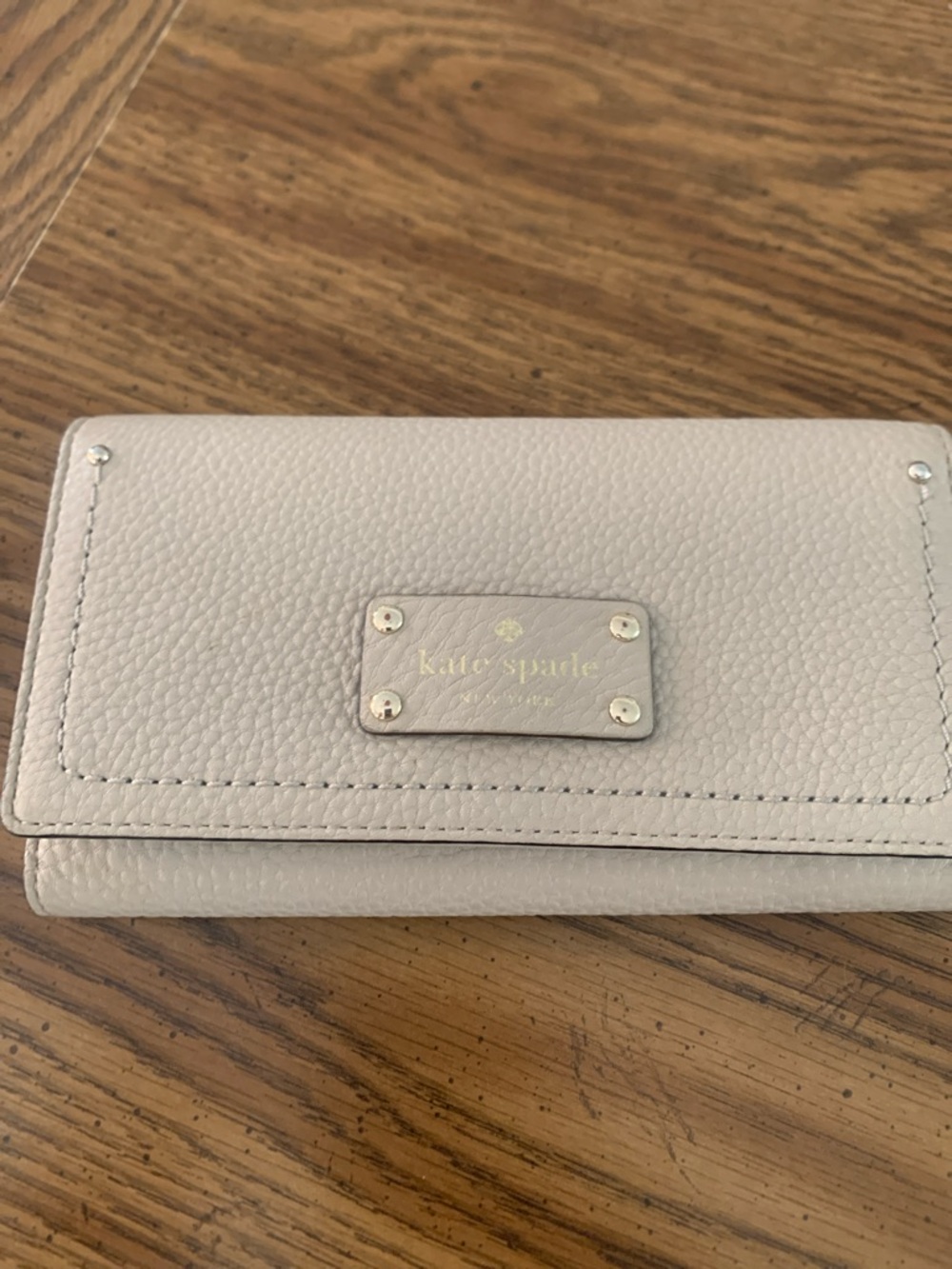 kate spade Cream Pebbled Leather Fold-Over Wallet with Gold Plaque